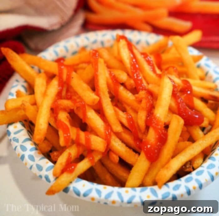 Crispy Air Fryer Frozen French Fries 2 Crispy air fryer frozen french fries in a basket, ready to be enjoyed.