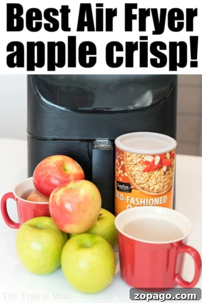 Air fryer apple crisp is amazing!! #applecrisp #airfryer #airfryerrecipes #airfryerdessert #applerecipe #airfryerapplecrisp #ninjafoodi #thetypicalmom Four individual air fryer apple crisps in mugs, ready to be served, showcasing the golden-brown oat topping.