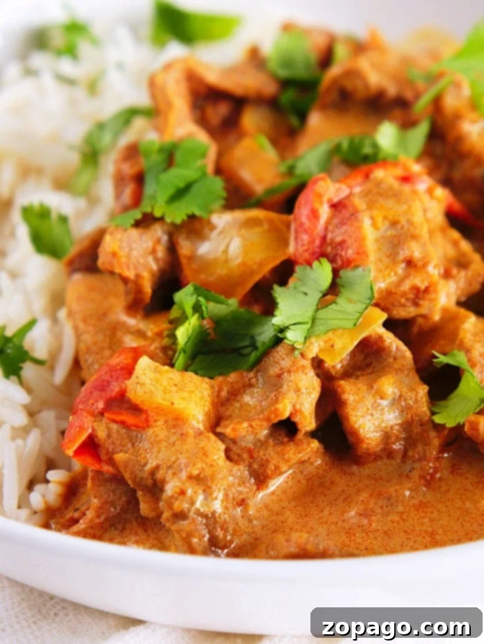Brown Butter Steak 6 A plate of butter beef with bell peppers, prepared in an Instant Pot, served with white rice and garnished with fresh cilantro.