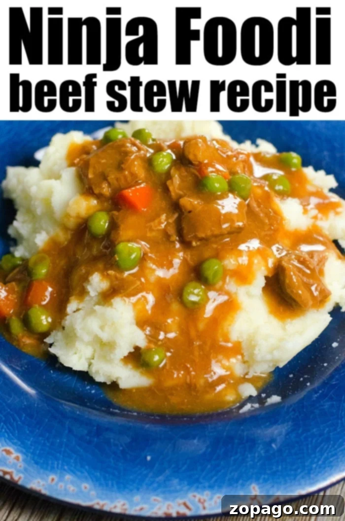 Ninja Foodi stew is a hearty beef dinner with mashed potatoes. Comfort food on a plate all cooked in your pressure cooker and air fryer appliance. #ninjafoodirecipes #ninjafoodi #stew #ninjafoodistew #beefstew A plate of Ninja Foodi beef stew brimming with peas and carrots sits invitingly over mashed potatoes on a blue plate.