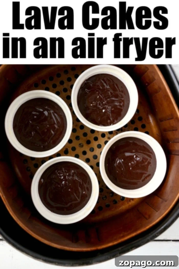 Air fryer lava cake will become your new favorite dessert! Ooey gooey chocolate lava cake made in ramekins inside your Ninja Foodi or other brand. #airfryerrecipes #airfryerdessert #airfryercake #chocolatecake #lavacake #ninjafoodirecipes #ninjafoodi #foodi Air fryer lava cake: A close-up of the rich chocolate center, topped with a dusting of powdered sugar.
