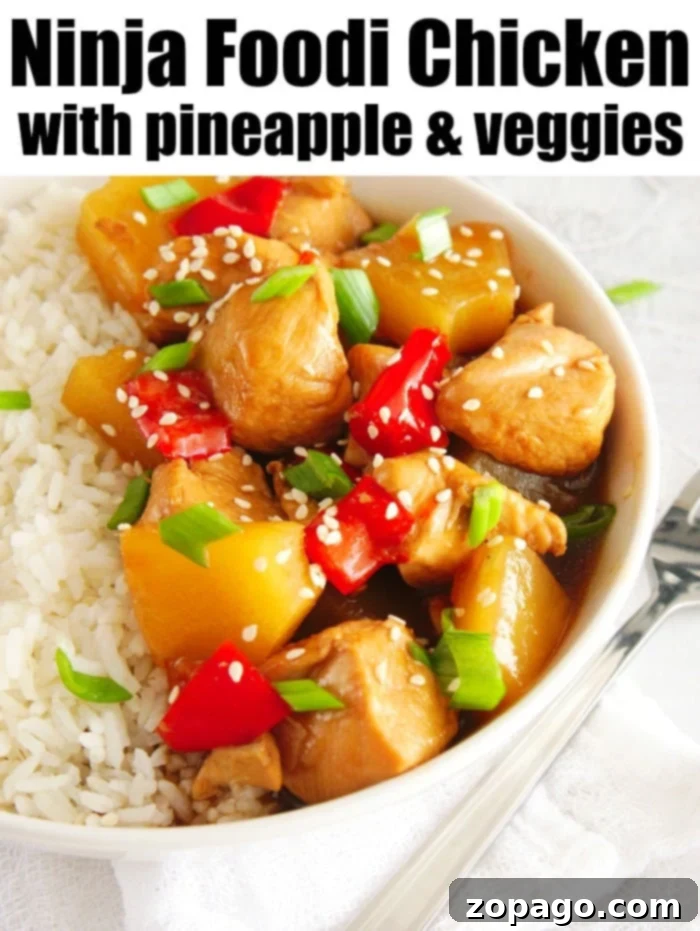 Ninja Foodi pineapple chicken is great served on top of rice. Cooked in no time with peppers and sweet fruit your family will love this pressure cooker meal. Close-up of a serving of Ninja Foodi pineapple chicken