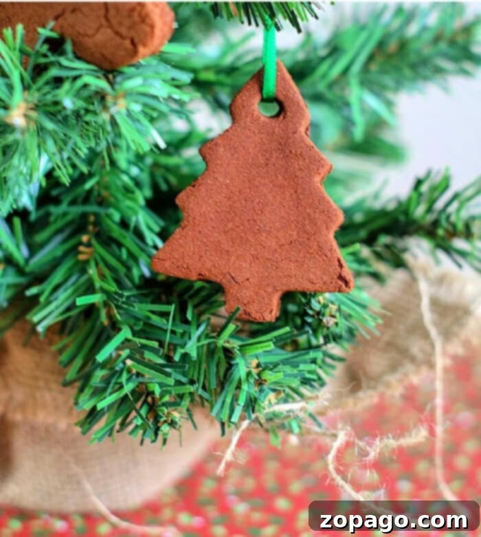 Simple Two-Ingredient Cinnamon Ornaments 2 Smiling children happily making applesauce cinnamon ornaments, a joyful family Christmas craft.