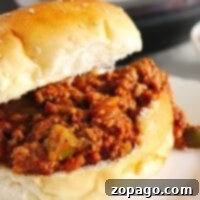 Enjoy a delicious Instant Pot Sloppy Joe sandwich with savory meat filling on a sesame seed bun.