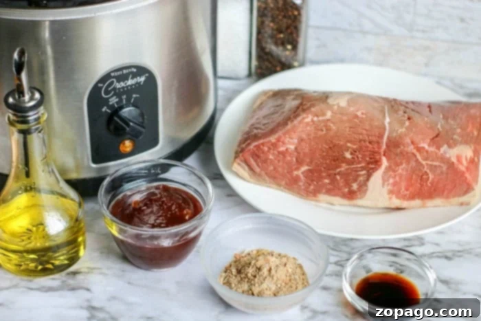 Tender Slow Cooker BBQ Beef 3 Crockpot shredded beef prepared for serving.