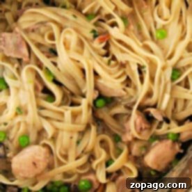 Savor the delightful twist on classic comfort food: Pasta with chicken, mushrooms, and peas gently stirred in a creamy sauce, reminiscent of an instant pot turkey tetrazzini.