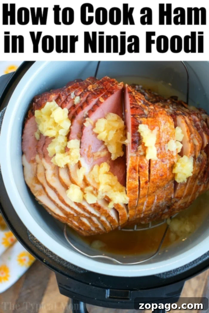 Holiday Ninja Foodi Ham Perfection A whole Ninja Foodi ham, surrounded by pineapple slices, perfect for holiday gatherings.