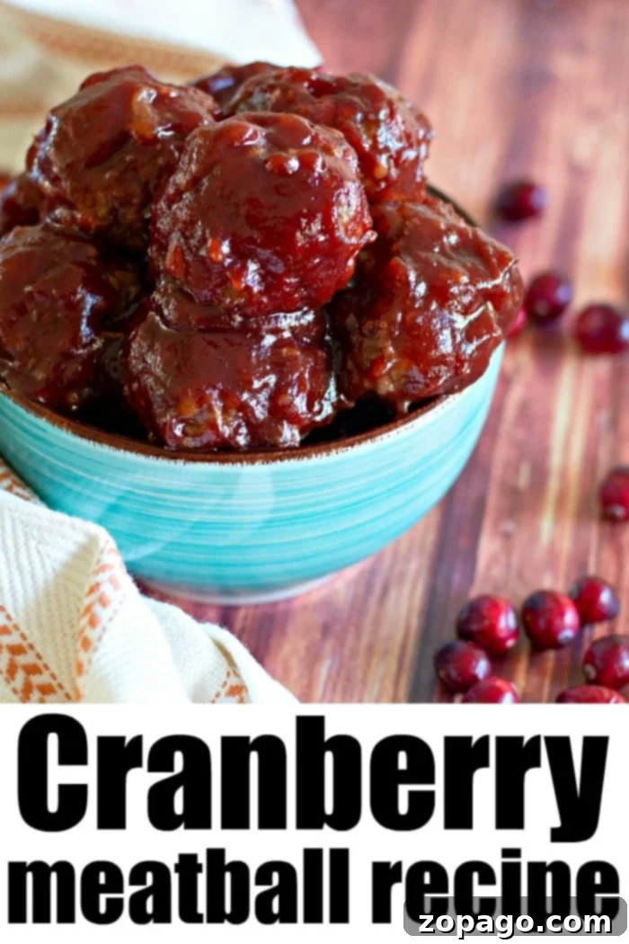 Cranberry meatballs are the best Christmas appetizer everyone will love. With a rich tangy sauce and tender homemade meatballs inside, these will be a hit. #cranberryrecipes #cranberry #meatballs #appetizer #christmasappetizer Close-up of the vibrant cranberry bbq sauce simmering in a saucepan, highlighting its smooth, rich texture.