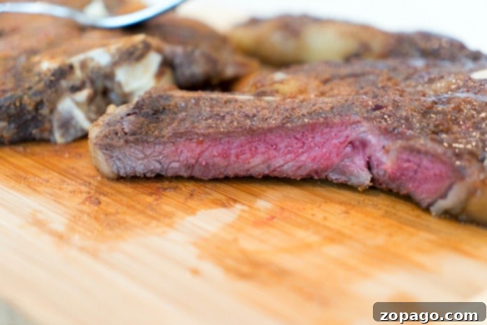 Perfect Ninja Foodi Steak and Creamy Mashed Potatoes 5 Perfectly cooked steak with a crispy crust, sliced and ready to serve.