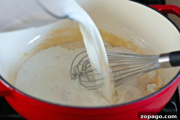 Creamy Homemade Dutch Oven Mac and Cheese 4 Homemade cheese sauce simmering in a pot