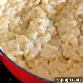 Close-up of easy homemade macaroni and cheese in a red pot, showcasing its creamy texture.