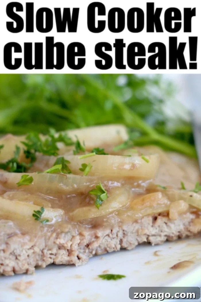 Tender Slow Cooker Cube Steak with Rich Mushroom Gravy Close-up of Slow Cooker Cube Steak with Mushroom Gravy and Onions, Ready to Serve
