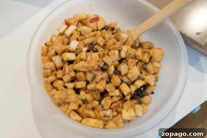 Golden Brown Sugar Apple Chunks 4 Diced apples mixed with cinnamon and brown sugar in a large mixing bowl.