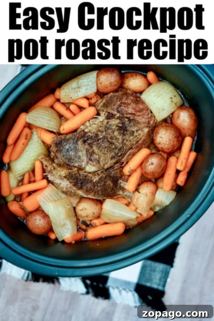 Crockpot roast is fantastic. Want to make your beef tender and shredded with just forks? Here are simple instructions to do just that. #crockpotroast #roast #slowcookerroast #crockpot #crockpotrecipes A delicious crockpot pot roast with a side of tender vegetables, ready to be served.
