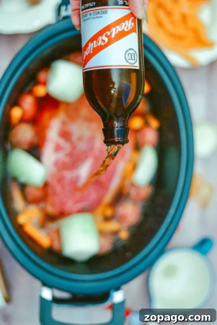 Roast with onion soup mix in Crockpot is fantastic. Want to make your beef tender and shredded with just forks? Here are simple instructions to do just that. #crockpotroast #roast #slowcookerroast #crockpot #crockpotrecipes A close-up of a fully cooked Crockpot roast with onion soup mix, showcasing the tender meat and vegetables.