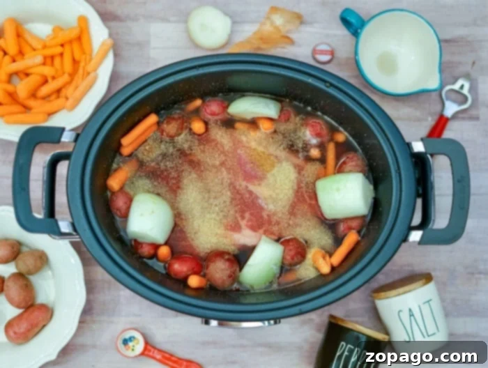 Foolproof Onion Soup Pot Roast 6 A large cut of beef roast cooking in a slow cooker with vegetables and liquid.