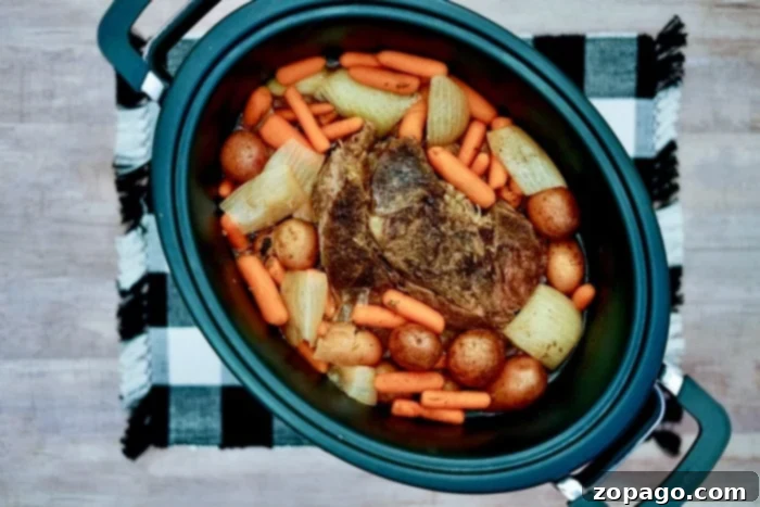 Foolproof Onion Soup Pot Roast 7 Tender shredded slow cooker pot roast served with vegetables and gravy.