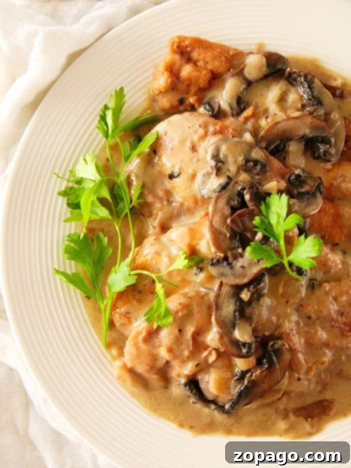 A serving of Instant Pot Chicken Marsala with a generous amount of mushroom gravy, ready to be enjoyed.