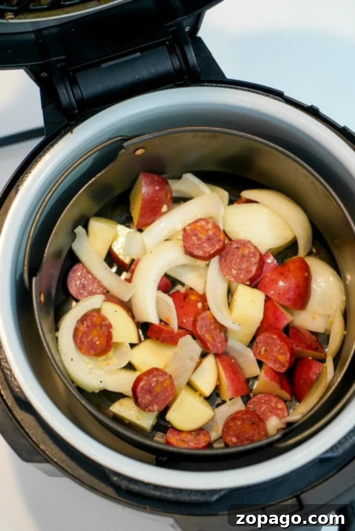 Ninja Foodi sausage and potatoes cooked together to perfection! Tender with a little crisp on the outsides makes this a hearty meal everyone will love. #airfryer #airfryerrecipes #ninjafoodi #foodi #ninja #ninjafoodirecipes #sausage #sausageandpotatoes #airfryerpotatoes Ninja Foodi sausage and potatoes, a delicious and easy meal