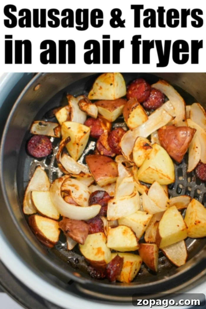 Air fryer sausage and potatoes cooked together to perfection! Tender with a little crisp on the outsides makes this a hearty meal everyone will love. A close-up view of air fryer sausage and potatoes, perfectly golden and crispy, garnished with fresh herbs.