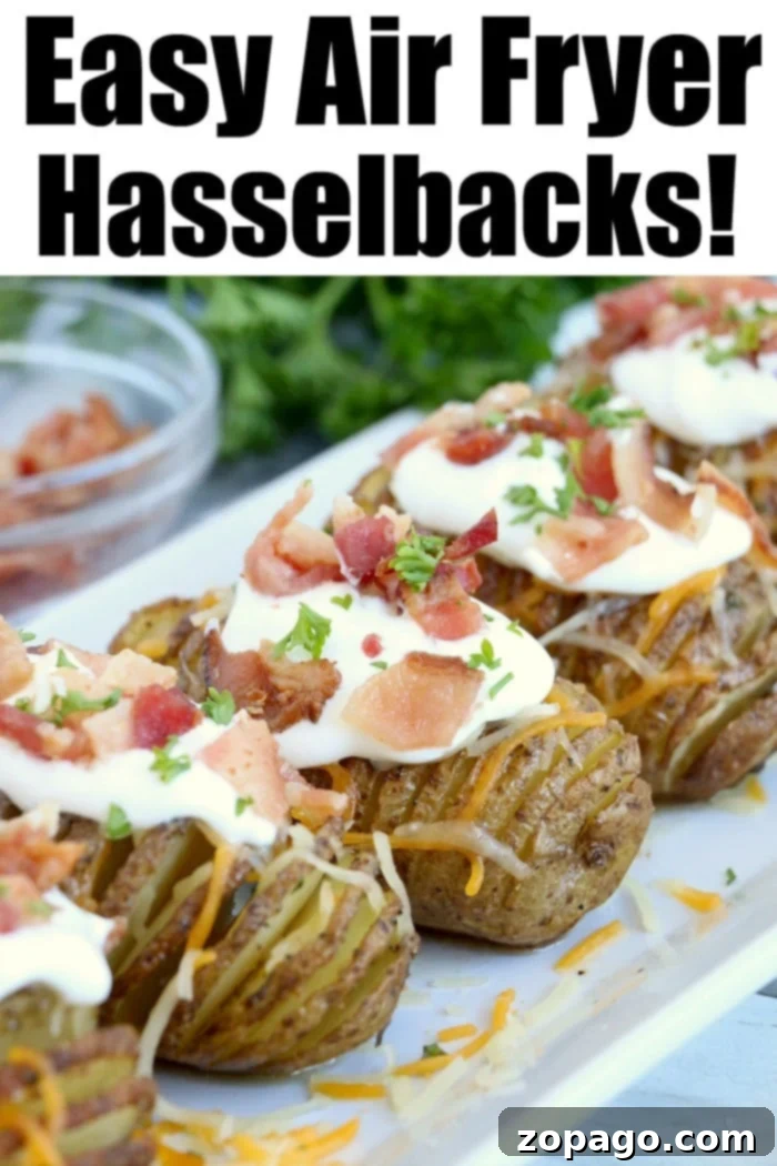 Crispy Air Fryer Hasselback Potatoes 7 Crispy air fryer Hasselback potatoes, generously topped with sour cream, crispy bacon, and fresh chives, presented on a white plate.