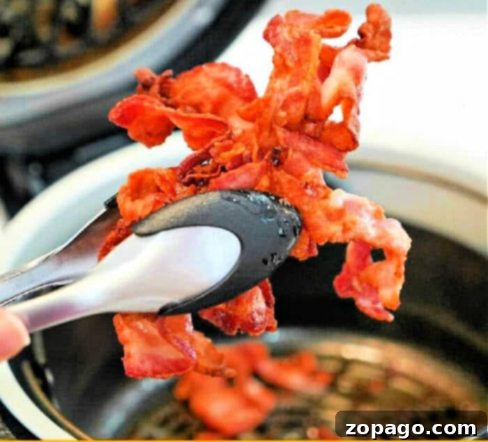Crispy Air Fryer Bacon 2 Perfectly crispy bacon cooked in a Ninja Foodi air fryer, showcasing the golden-brown results.