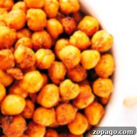 Crispy Air Fryer Chickpeas 6 A close-up view of a bowl filled with golden brown, crispy air fryer chickpeas, perfectly roasted and seasoned to perfection.