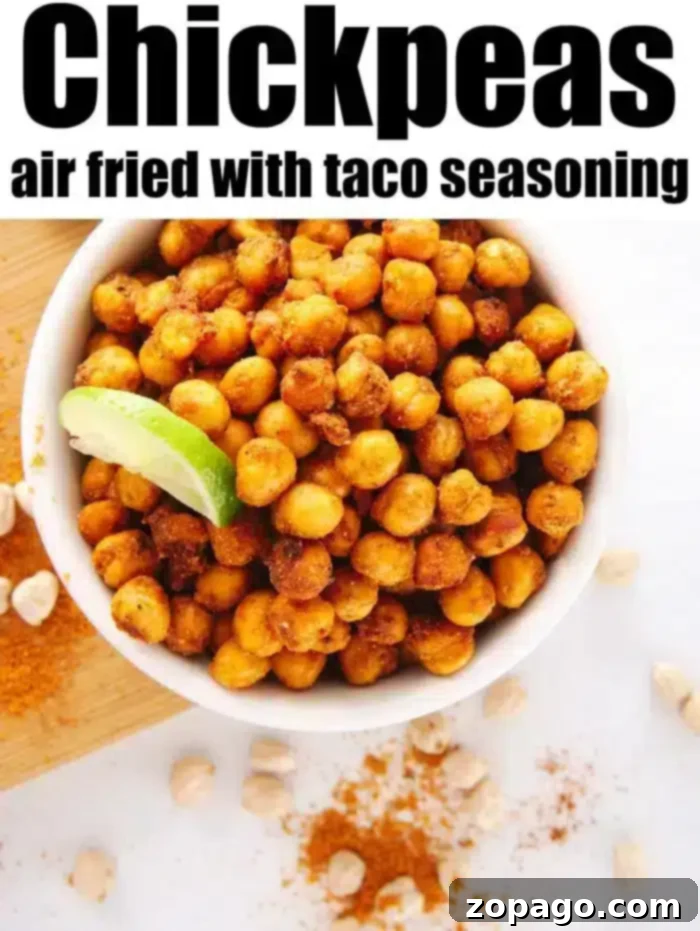 Crispy high protein air fryer chickpeas tossed in taco seasoning for a quick snack on the go. A bowl of crispy air fryer chickpeas, showcasing their golden color and crunchy texture. Perfect for a healthy snack.