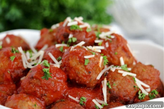 Crispy Air Fryer Frozen Meatballs 6 Delicious, sauced meatballs served in a bowl, garnished with herbs.
