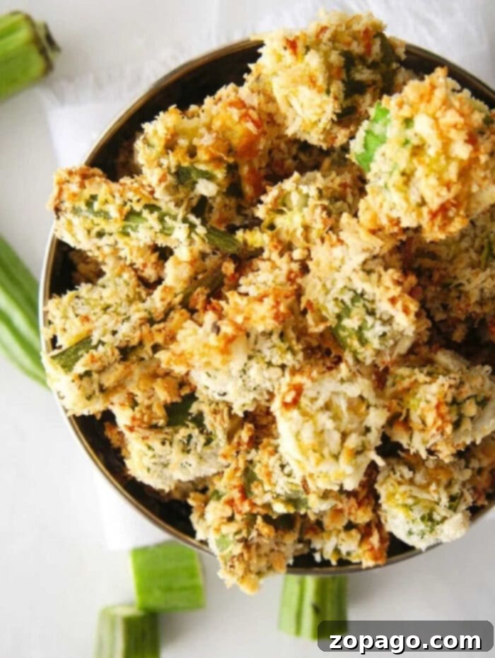 Golden Crispy Air Fryer Okra 2 Crispy air fryer okra pieces coated in Panko breadcrumbs, ready to be served as a delicious side dish.