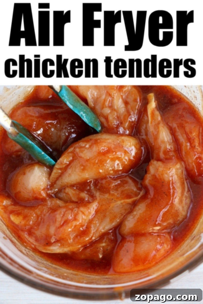 Healthy and flavorful air fryer chicken tenders no breading, marinated and ready for cooking. Raw chicken tenders marinated in a barbecue sauce lie ready for the air fryer in a glass bowl with blue tongs, perfect for those who prefer no breading.