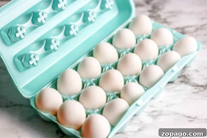 Skip the Pot: Oven Hard Boiled Eggs 3 Fresh white eggs nestled in a muffin tin, prepared for oven baking to become perfectly hard boiled.