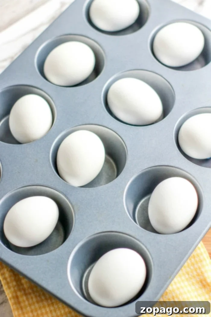 Skip the Pot: Oven Hard Boiled Eggs 8 Oven hard-boiled eggs in a muffin pan, showcasing the simple method for perfect results every time, great for any meal or occasion.