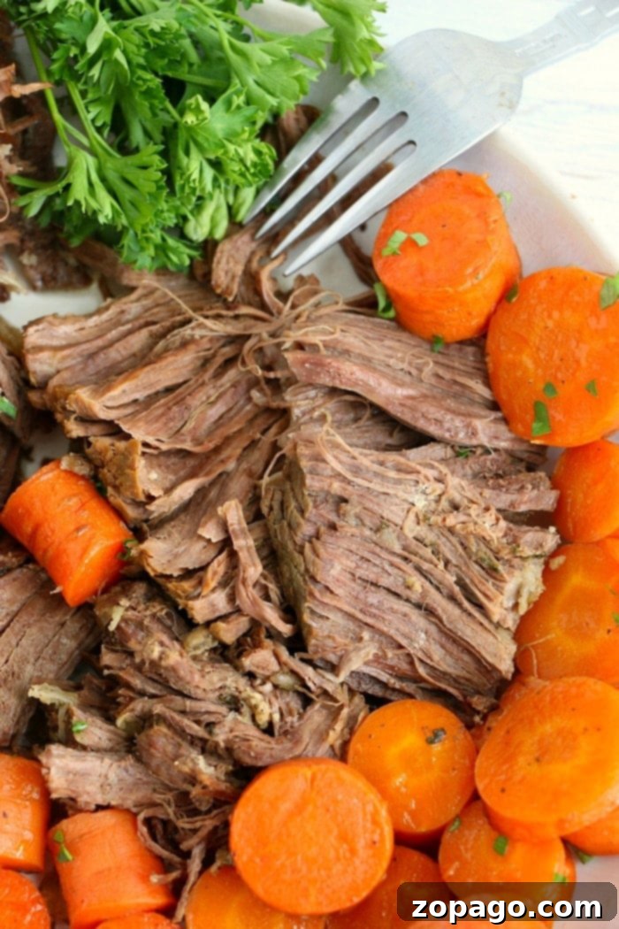 Cooking a frozen roast in Instant Pot is possible! You can still get a tender, flavorful, piece of beef even if it is not thawed out beforehand. Here's how! #instantpot #roast Shredded roast beef on a plate, ready to be served