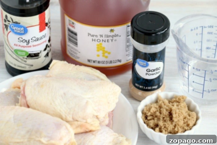 Juicy Air Fryer Marinated Chicken Thighs 4 Teriyaki chicken thighs marinating in a bowl
