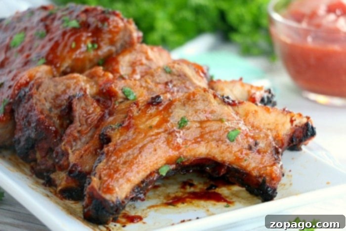 Fall Off The Bone Air Fryer Ribs 4 air fryer filled with food, ready for cooking