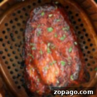Succulent ribs glazed with herbs are perfectly cooked in a Ninja air fryer, then placed in a perforated pan.