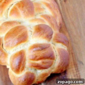 Homemade Yeast Bread from Scratch 6 Golden braided loaf of bread on a wooden surface, showcasing the perfection achieved with homemade bread recipes with yeast.