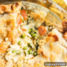 From-Scratch Leftover Turkey Pot Pie 10 A close-up of a leftover turkey pot pie with a flaky crust reveals carrots, peas, and a rich filling without cream of chicken.