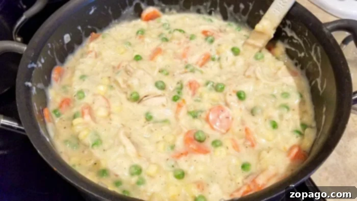 From-Scratch Leftover Turkey Pot Pie 5 A roux being made in a skillet, combining butter, flour, and seasonings.