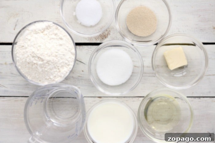 Air Fryer Bread Made Simple 2 Essential ingredients for homemade bread laid out on a kitchen counter: flour, yeast, sugar, salt, milk, water, and oil.