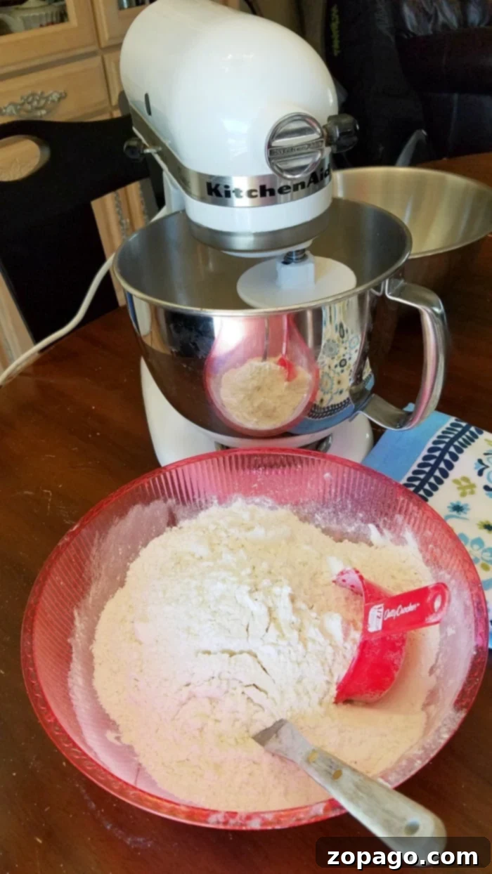 How to make homemade white bread dough. A stand mixer with dough hook expertly kneading fluffy homemade white bread dough to a smooth, elastic consistency.