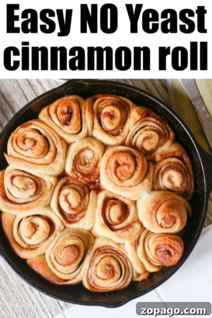 Fluffy Sourdough Discard Cinnamon Rolls 2 Freshly baked sourdough cinnamon rolls, golden brown and drizzled with icing, in a cast iron skillet.
