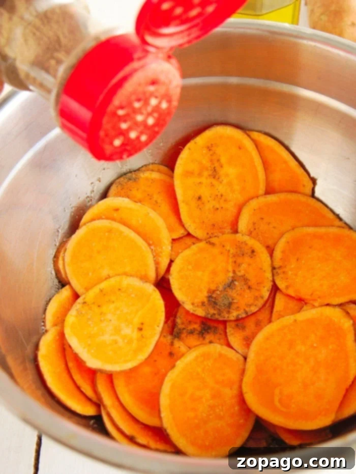 Crispy Air Fryer Sweet Potato Chips 5 Crispy homemade potato chips being prepared, showcasing the thin slices before air frying.