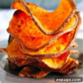 Crispy Air Fryer Sweet Potato Chips 6 A stack of crispy, homemade sweet potato chips air fryer-style sits on a plate, perfectly golden and delicious.
