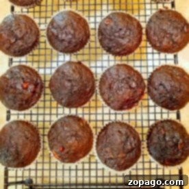 Chocolate banana muffins cooling on a wire rack, arranged in rows.