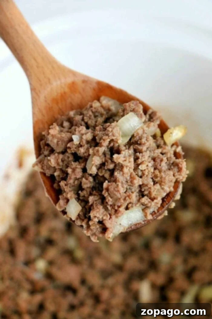 Flavorful Crockpot Ground Beef 2 Close-up of seasoned raw ground beef in a slow cooker, ready for cooking