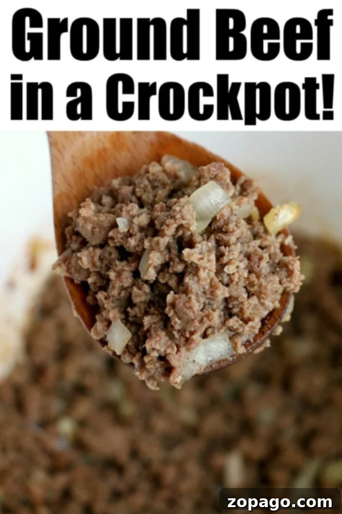 Flavorful Crockpot Ground Beef 10 Cooked crockpot ground beef in a white bowl with a spoon, ready to be served or used in a recipe.