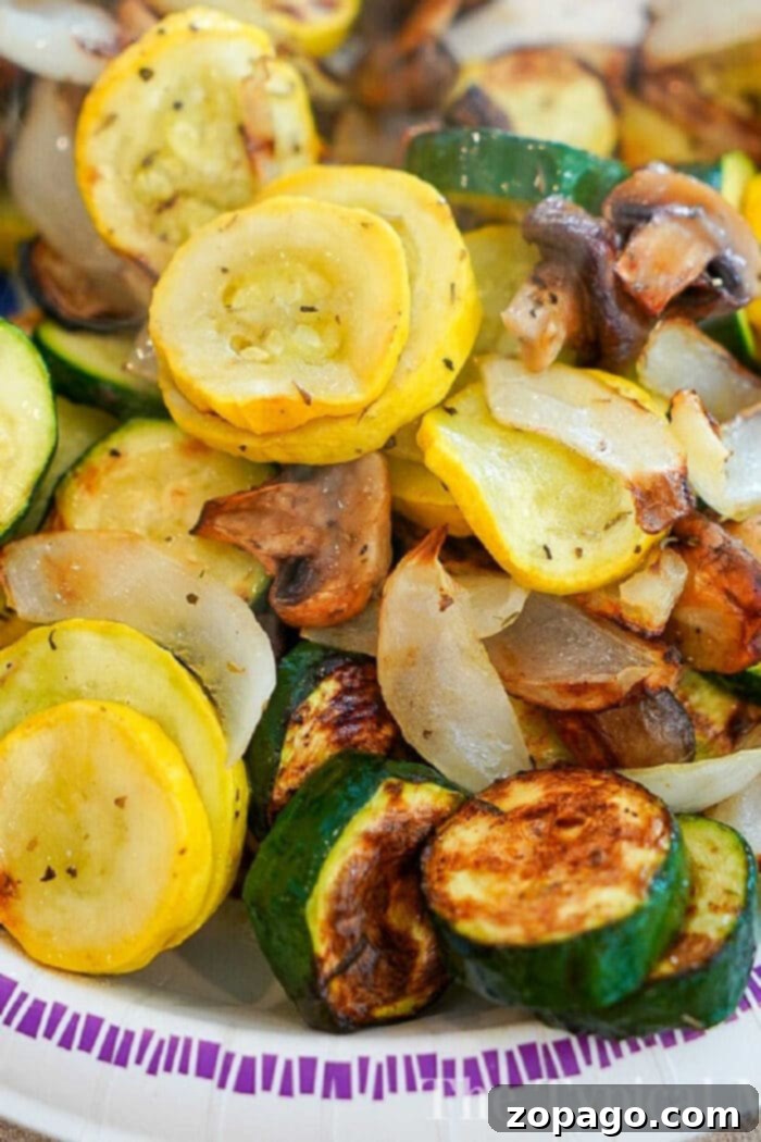 Crispy Air Fryer Vegetable Dishes 2 A plate of delicious air fried vegetables, including yellow squash, zucchini, onions, and mushrooms, showcases the ease and flavor of air fryer vegetable recipes.
