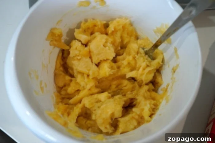 Super Easy 4 Ingredient Banana Bread Muffins 5 Close-up of mashed ripe bananas in a bowl, ready for baking